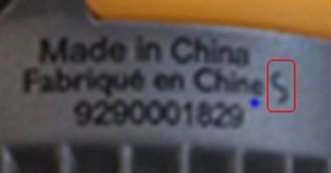 The factory code, a slanted “S,” and other information printed on the ceramic band on the neck of the bulbs.